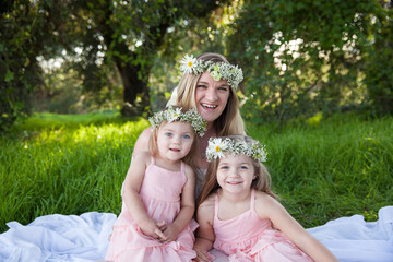 Joyful family moment with flower crowns in sunlit meadow