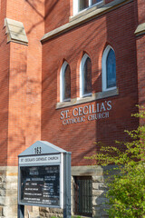 Obraz premium notice or signboard and sign outside St Cecilia's Catholic Church located at 161 Annette Street in Toronto, Canada