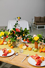 Colorful dining table with a fresh citrus and floral theme.