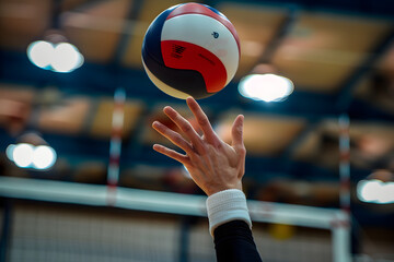 Close-up of a volleyball player's hands serving the ball, capturing the power and precision of the serve