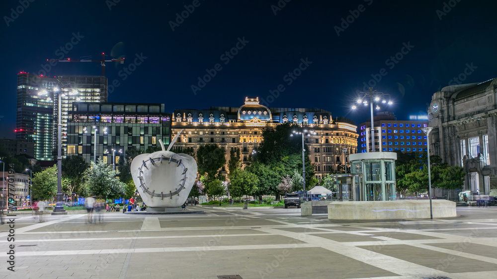 Wall mural the monumental sculpture the reintegrated apple in front of milan's central railway station night ti