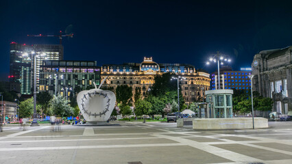 The monumental sculpture The Reintegrated Apple in front of Milan's central railway station night...