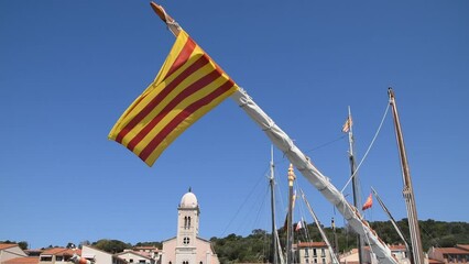 A flag of Catalonia on the bowsprit of the sailing vessel