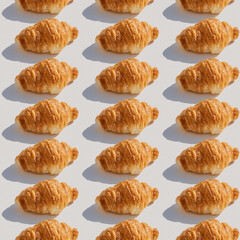 Seamless pattern with freshly baked croissant on white background..