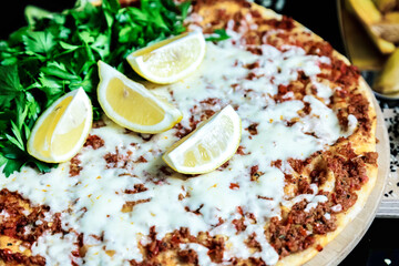 Close-Up of Pizza With Lemons and Parsley