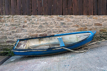 Old weathered row boat outside the water