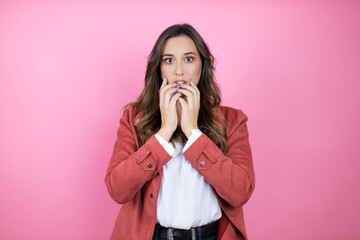 Young beautiful woman wearing casual jacket over isolated pink background looking stressed and...