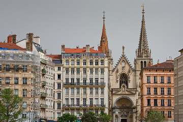 Saint-Nizier church bell towers and facade of buildings of Saone river banks in Lyon