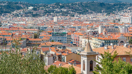Bright sun lights red roofs of the old city timelapse. Aerial view from Shatto's hill. Nice, France