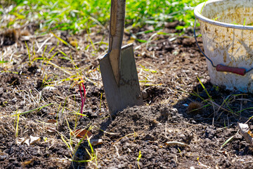 Close-up of spade and bucket at garden of Swiss farm at Swiss City of Zürich on a sunny spring day. Photo taken April 27th, 2024, Zurich, Switzerland.