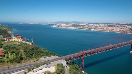 Fototapeta na wymiar 25th of April Suspension Bridge over the Tagus river, connecting Almada and Lisbon in Portugal timelapse