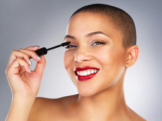 Makeup, mascara and portrait of woman with red lips in studio for lipstick and eyelash routine. Cosmetics, beauty and face of female person with facial cosmetology treatment by gray background.
