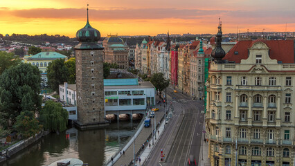 Sitkovska water-tower timelapse and traffic on road in old city center of Prague at sunset time.