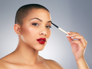 Eyeshadow, brush and portrait of woman with red lips in studio for lipstick and makeup routine. Cosmetics, beauty and face of female person with facial cosmetology treatment by gray background.