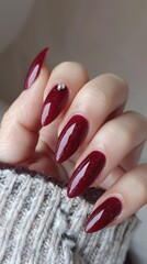 a hand with long nails with red nail polish