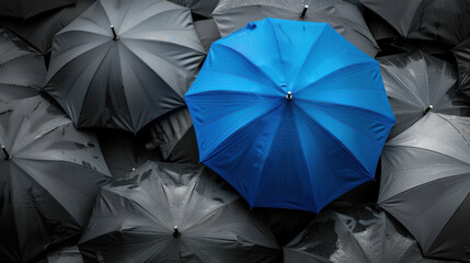 Blue umbrella on top of other gray umbrellas. Business and safety concept