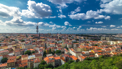 Timelapse view from the top of the Vitkov Memorial on the Prague landscape with the famous Zizkov TV tower on the horizon - obrazy, fototapety, plakaty