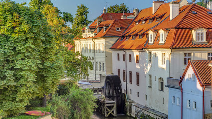 Beautiful timelapse view of a street with old water mill in a canal in center of Prague © HyperlapsePro