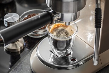 Automatic coffee machine. Pouring coffee into the coffee cup closeup. - obrazy, fototapety, plakaty