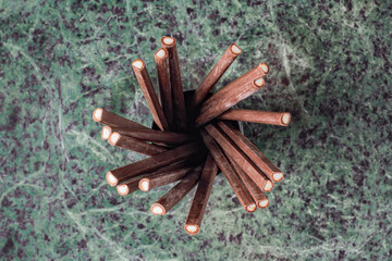 Overhead shot of dark chocolate covered mint sticks on marble top