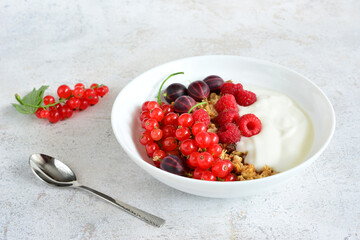 a bowl of raspberry, gooseberry and currant with granola and yogurt