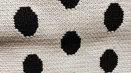 Macro polka dot on textile. Close-up view of elastic fabric with black and white polka circles...
