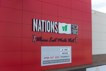 Obraz premium exterior wall and sign of Nations Experience, a supermarket, located here at 1980 St Clair Avenue West in Toronto, Canada