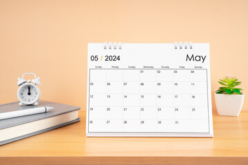 May 2024, Monthly desk calendar for 2024 year on wooden table.