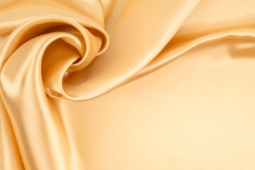Close-up shot of gold satin texture background.