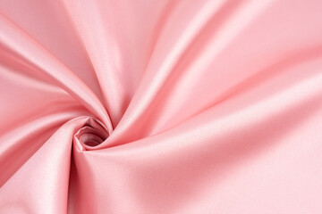 Texture of the satin fabric of pink color for background.
