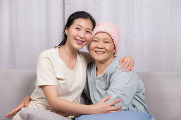 Senior woman breast cancer sickness embraces daughter spends joyful time sitting together bonding...