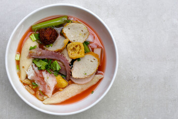 A bowl of pink flat noodles