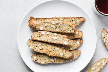 almond biscotti on a white plate, almond cantucci cookies on a white plate, flatlay of biscotti cookies or twice baked cookies