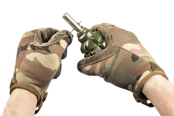 Man`s hand in tactical gloves removes safety pin of old green shrapnel Hand Grenade Weapon of War...