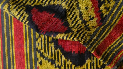 Handmade woven textile with unique pattern from Indonesia,  close up textured multicolor fabric background, traditional clothing in southeast asia