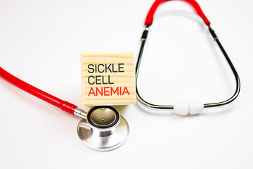 SICKE CELL ANEMIA text on wooden cube with stethoscope on white background,medical concept.