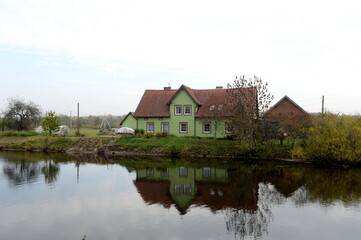 Fototapeta na wymiar House on the bank of the Polessky Canal in the village of Belomorskoye, Kaliningrad region