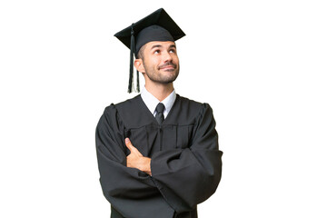 Young university graduate man over isolated background looking up while smiling