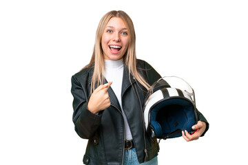 Young pretty blonde woman with a motorcycle helmet over isolated chroma key background with...