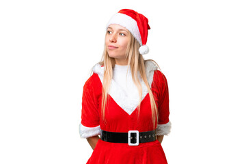 Young blonde woman with christmas hat over isolated chroma key background looking to the side