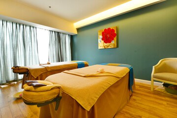Interior of Spa room consisting of bench pillows towels and low level lighting