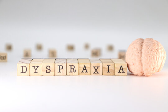 Dyspraxia word on wooden cubes isolated on white background