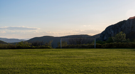 Football field with green grass at sunny day. Soccer field in the rural. Soccer field in the...