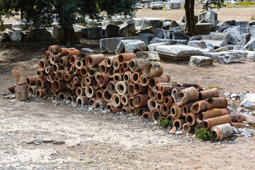 Pile of ancient terracotta pipes in Ephesus, a testament to Roman engineering and historical...