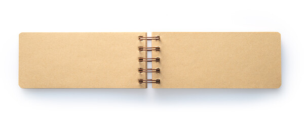 Open, empty kraft paper notebook with a spiral binding, lying flat.