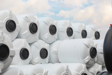 black and white water tanks, plastic PVC ,organized next to each other