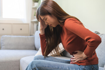 Flatulence ulcer, asian young woman, girl hands in belly, stomach pain from food poisoning,...