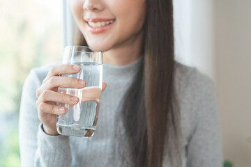 Happy beautiful, asian young woman, girl drinking, sip fresh glass of water for hydration of body,...