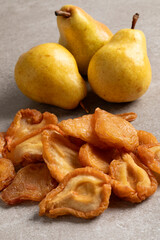 Heap of dried pear fruit and fresh pears close up