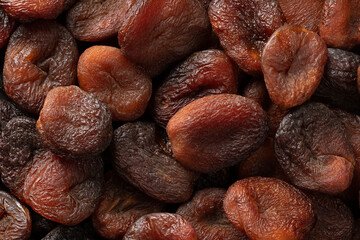 Natural unsulphured sun dried brown Turkish apricots fruit close up full frame as background